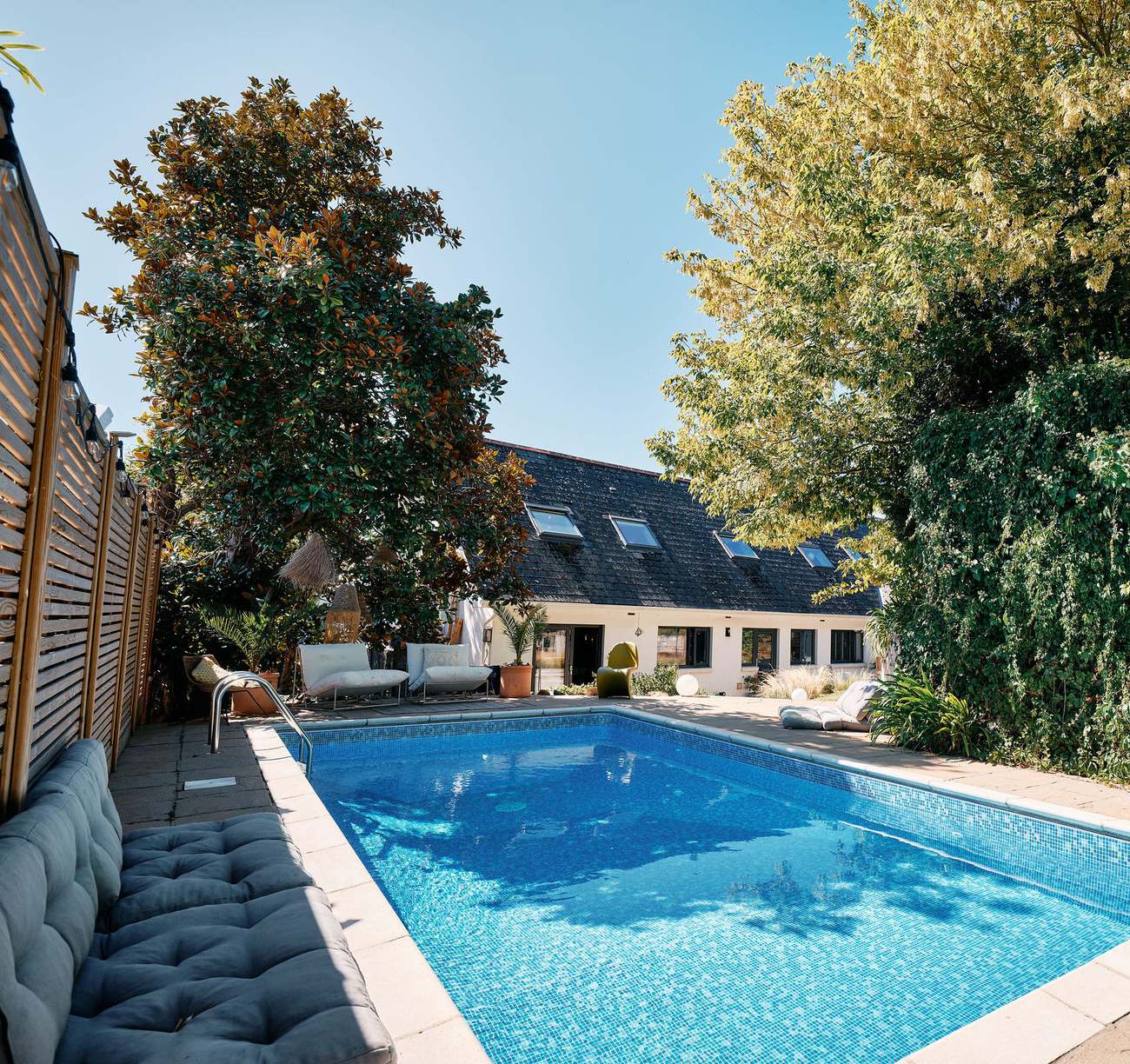 The heated pool in its suntrap deck, with the house behind