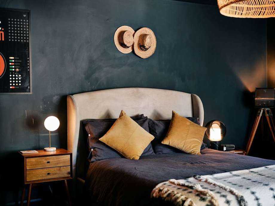 The guest bed with mustard cushions
