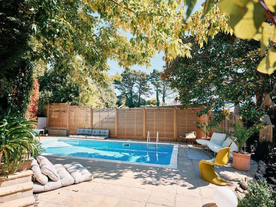 The pool from above the cushions, under the trees